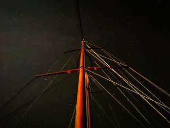 Low angle view of illuminated ferris wheel against sky at night