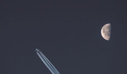 Low angle view of half moon against sky at night