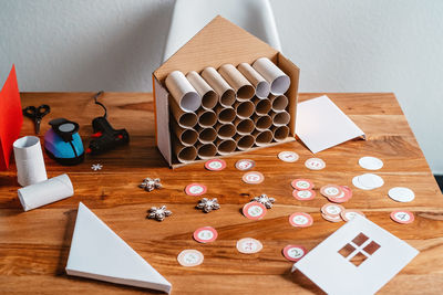 Process of making handmade advent calendar house from toilet paper rolls. sustainable christmas,