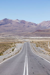 Empty road along countryside landscape