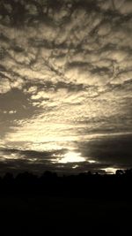 Silhouette of landscape against cloudy sky