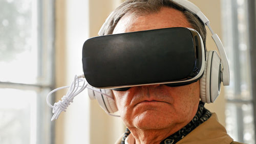 Close-up of man wearing virtual reality simulator