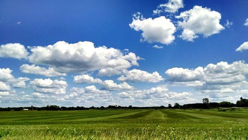 Scenic view of field against cloudy sky