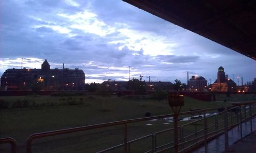 Railroad tracks against cloudy sky