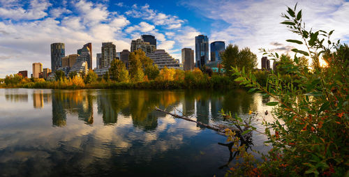 Scenic view of lake by buildings against sky