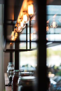 Close-up of illuminated light bulb on table at home