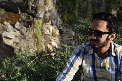 Portrait of young man wearing sunglasses outdoors