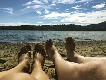 Low section of people relaxing at beach