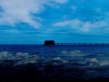 Scenic view of sea against blue sky