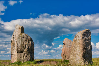 Panoramic view of rock on field against sky