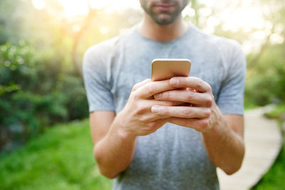 Midsection of woman using mobile phone