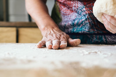 Close-up of man preparing food on table