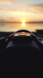 Close-up of car against sky during sunset