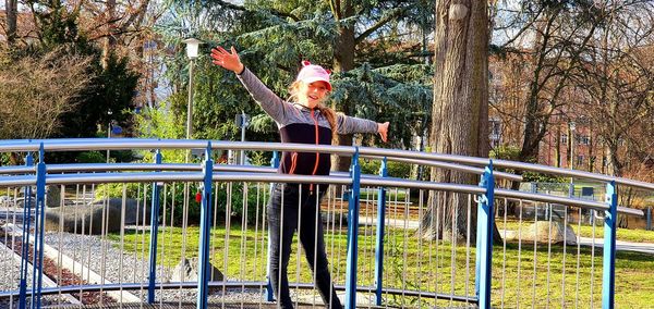 Portrait of woman standing on footbridge