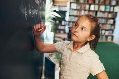 Student writing on blackboard. smart student put solve on chalkboard. back to school. learning