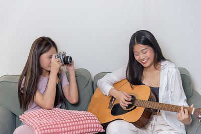 Portrait of smiling friends sitting at home