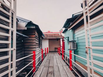 Footpath amidst buildings against sky