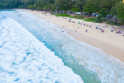  aerial view nature landscape ocean wave foam on the sand beach and travel tourists at surin beach