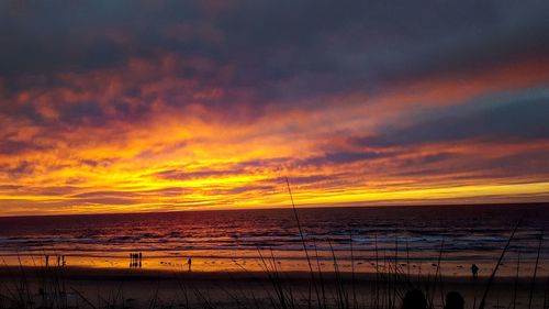 Scenic view of beach against sky during sunset