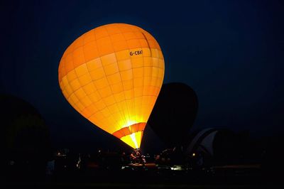 Hot air balloons in city at night