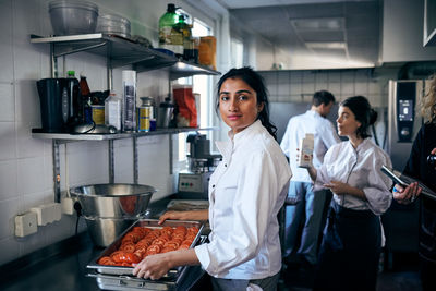 Portrait of woman standing in kitchen