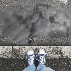 Low section of person standing on street