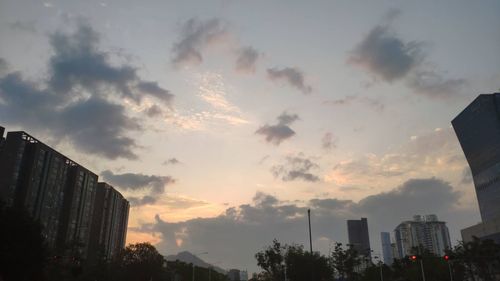 Low angle view of buildings against sky during sunset