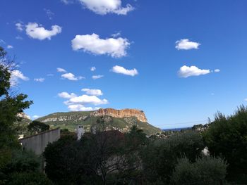 Scenic view of mountains against blue sky