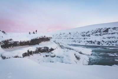 Frozen landscape against sky