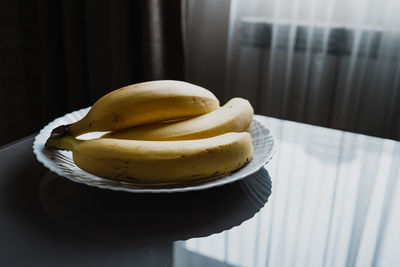 Ripe yellow bananas in a plate on the table. high quality photo