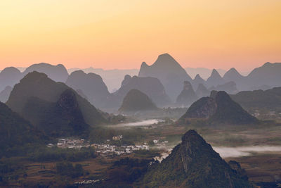 Scenic view of silhouette mountains against sky during sunset