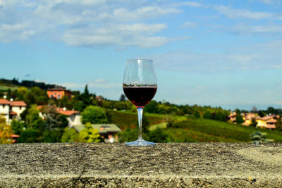 Close-up of wineglass against sky