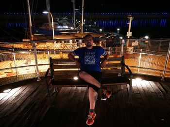 Portrait of man in illuminated park at night