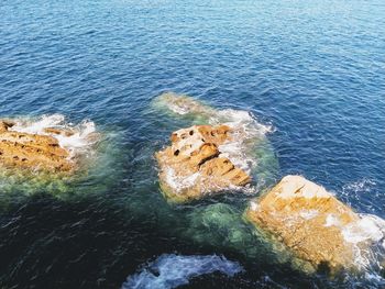 High angle view of rocks in sea