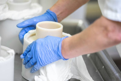 Close-up of hands holding coffee cup