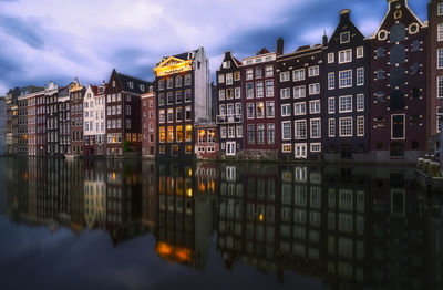 Reflection of buildings on river in city