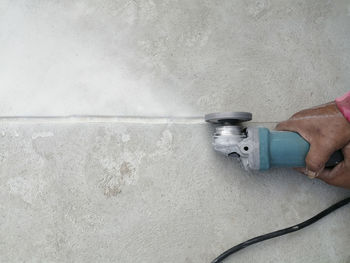 Close-up of man working against wall