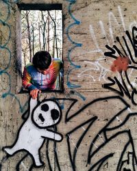 Young man with graffiti on wall