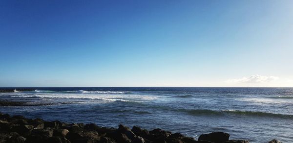 Scenic view of sea against clear blue sky