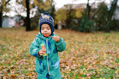 Portrait of boy standing on field