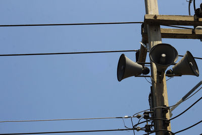 Low angle view of telephone pole against clear sky