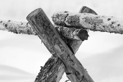 Low angle view of old wooden post against sky