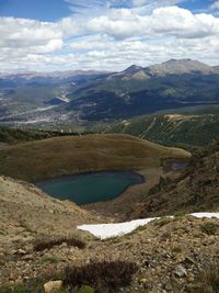 Scenic view of mountains against cloudy sky