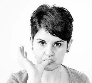 Close-up portrait of young woman over white background