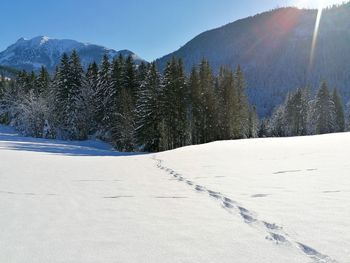 Snow covered landscape against sky