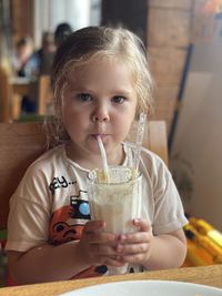 Portrait of boy drinking glass