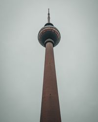 Low angle view of communications tower against sky