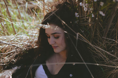 Close-up of woman against plants