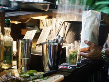 Midsection of man preparing food in glass container