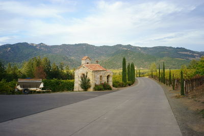 Empty road leading towards mountain